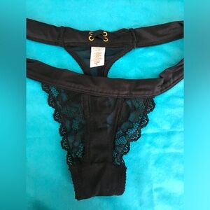 EUC 90’s VS black lace & satin thong with back tie and gold metal accents.